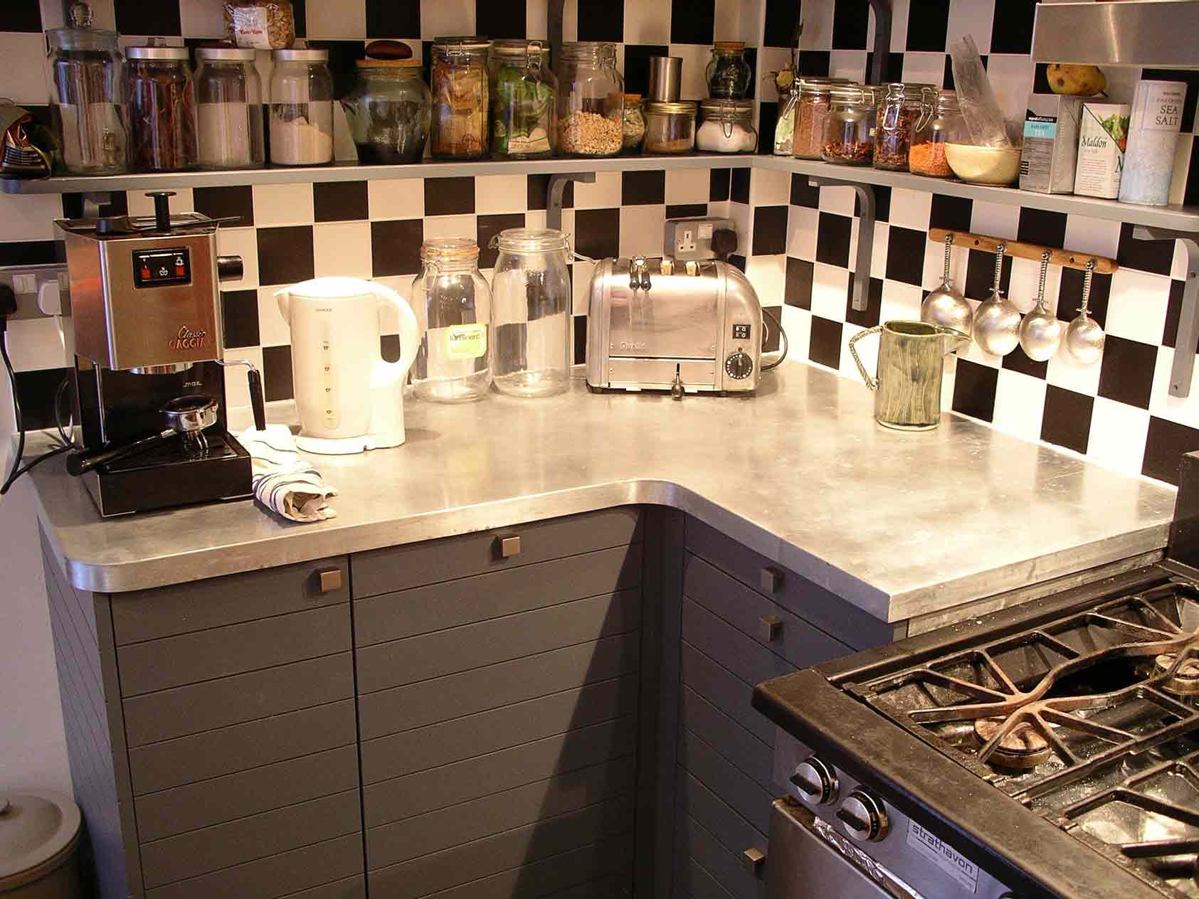 bespoke kitchen cabinets with horizontal slatted doors and custom made zinc worktop