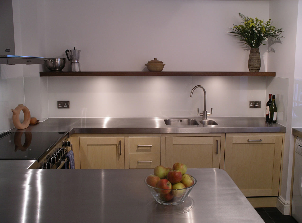custom built fitted kitchen with stainless steel worktops