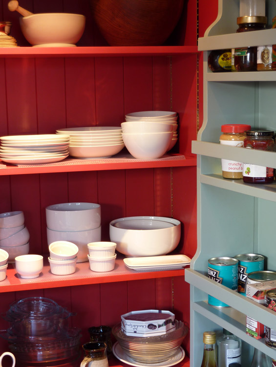 classic larder cupboard interior view showing shelving on doors