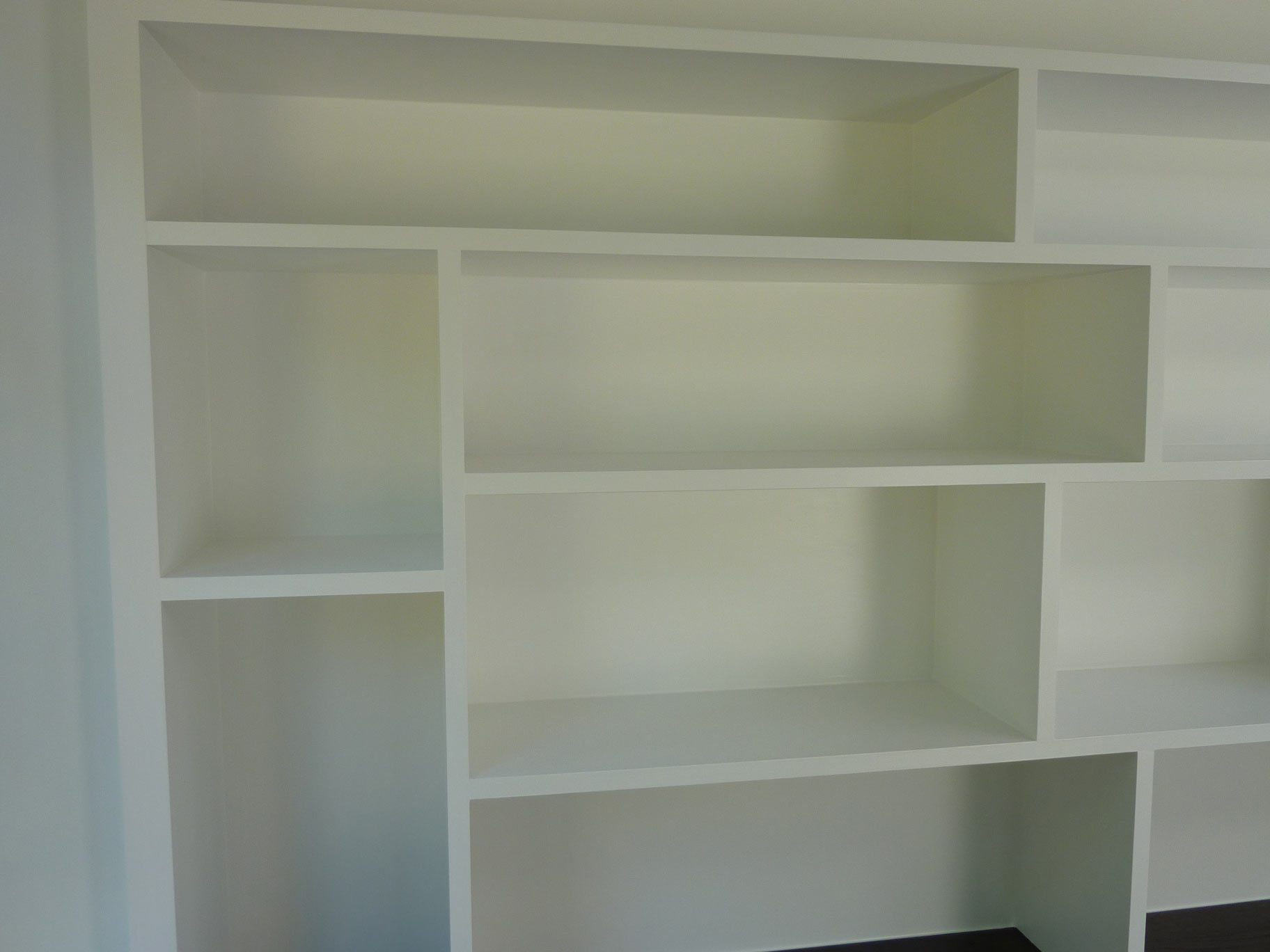 random shelving for books, box files, and decorative items in custom made fitted study
