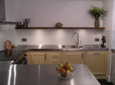 custom made fully framed kitchen with bespoke stainless steel worktops