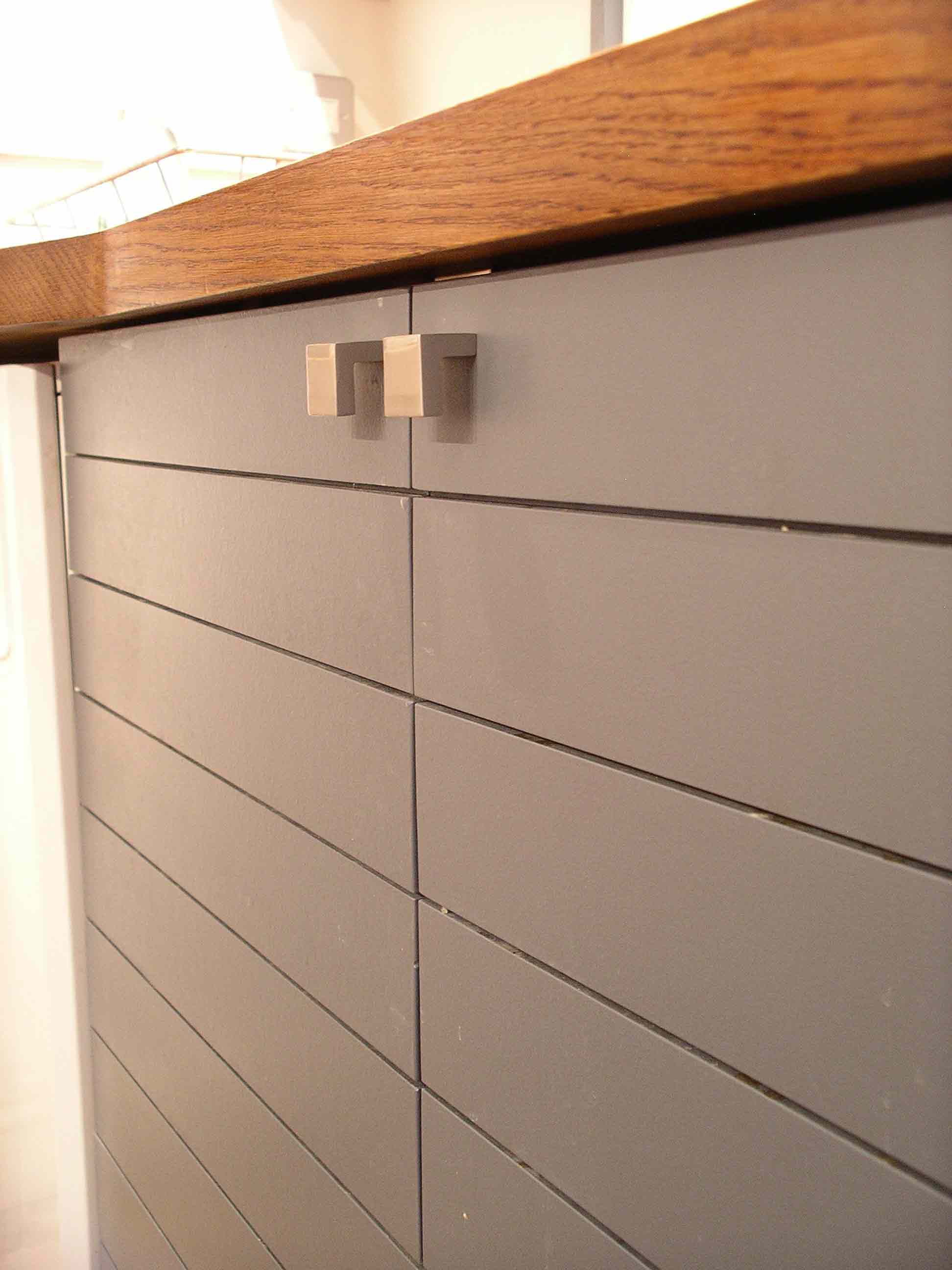 detail of slatted door design built in solid hardwood