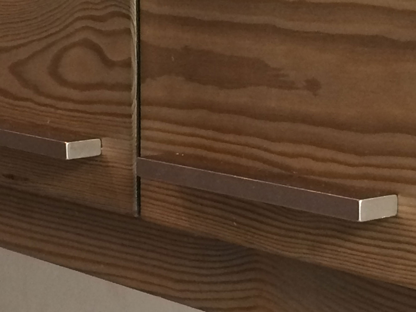 brushed steel handles on aged wood kitchen